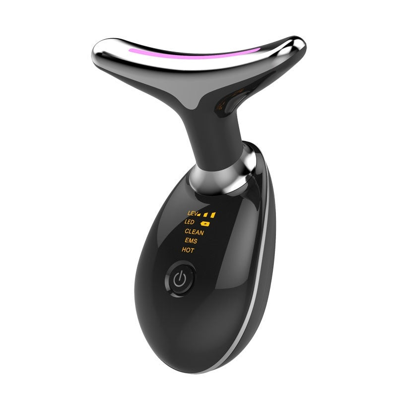 Black and silver facial massager on a white background